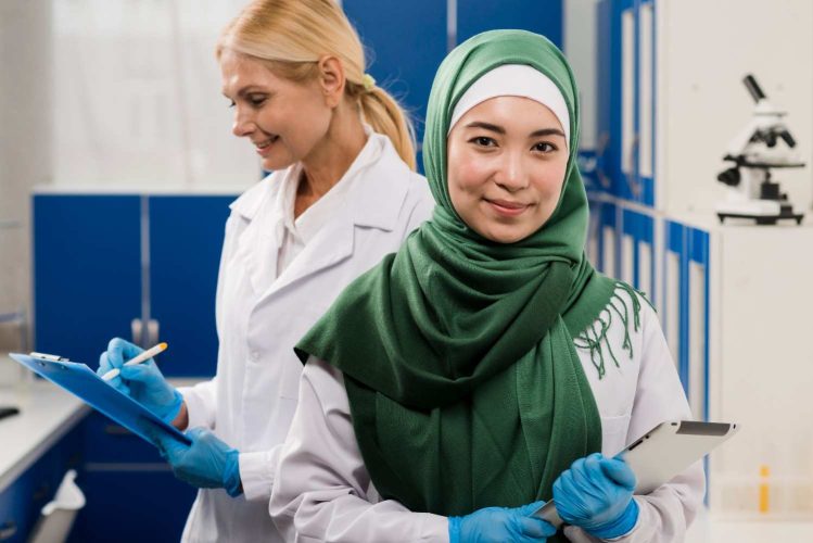 front-view-female-scientist-with-hijab-posing-lab-with-colleague (2)
